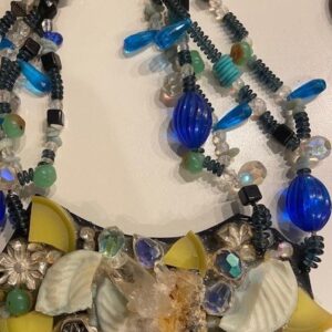 A necklace with blue and yellow beads on it.