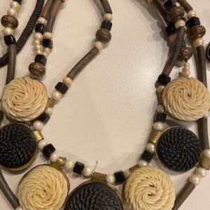 A necklace with black and white beads and pearls.