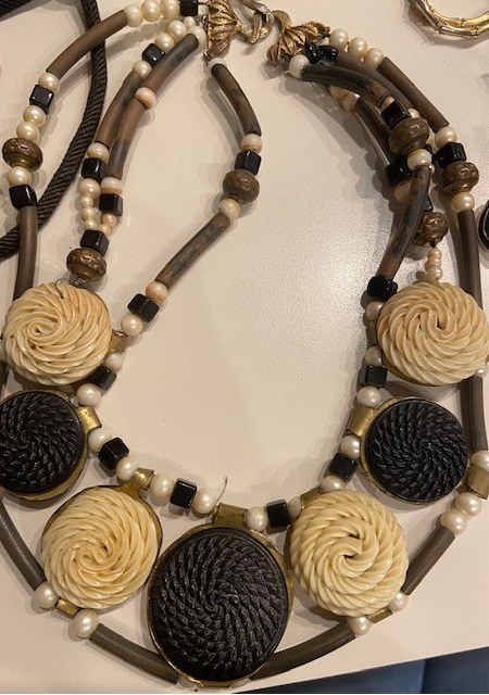 A necklace with black and white beads and pearls.