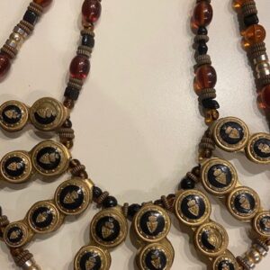 A necklace with a black and brown bead on it.