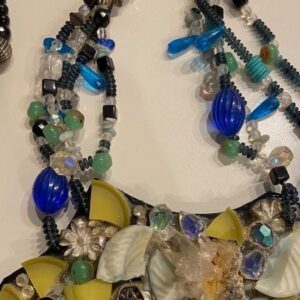 A necklace with beads and shells on it.