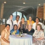 A group of women posing for a picture at a restaurant.