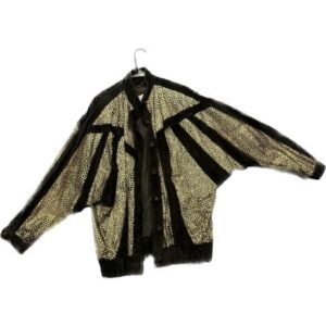 A black and gold jacket hanging on a hanger.