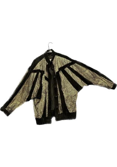 A black and gold jacket hanging on a hanger.