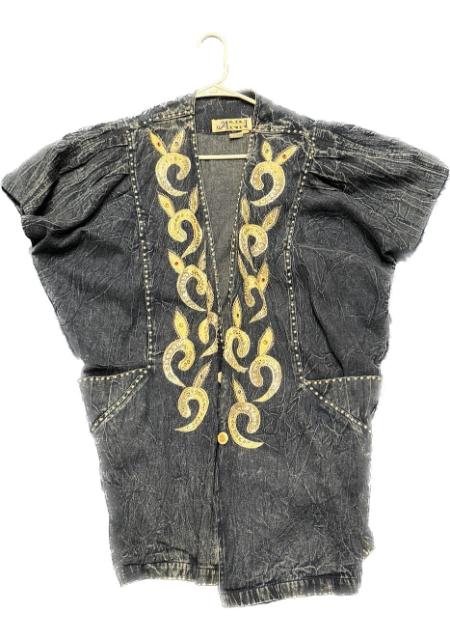 A denim jacket with gold embroidery on it.