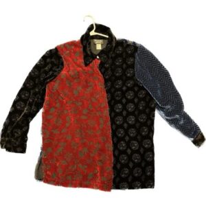 A black, red, and blue jacket hanging on a hanger.