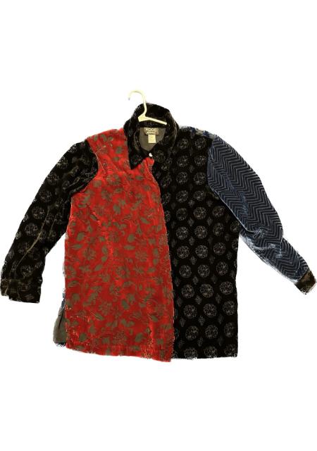A black, red, and blue jacket hanging on a hanger.