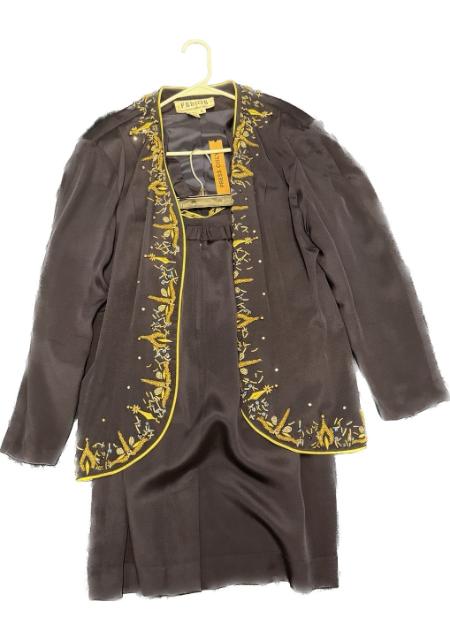A black and gold jacket with yellow embroidery.