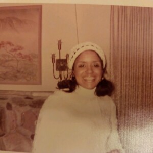An old photo of a woman in a white sweater.