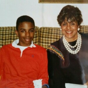 A woman and a young man sitting on a couch.