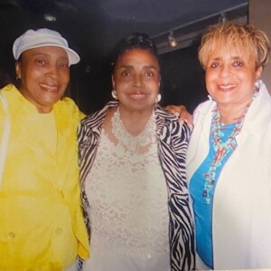 Three women posing for a photo with each other.