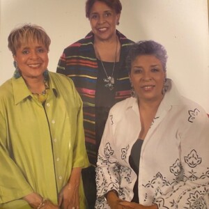 Three women are posing for a picture.