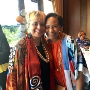 Two women posing for a photo at an event.