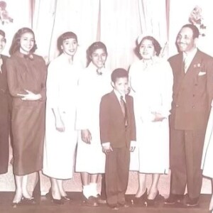 A black and white photo of a family posing for a picture.