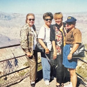 Four women posing for a picture at the grand canyon.