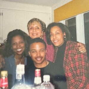 A group of people posing for a photo in a kitchen.
