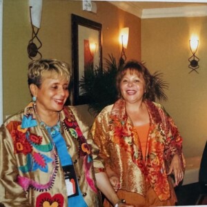 Three women standing next to each other in a room.