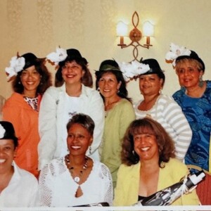 A group of women in hats posing for a photo.