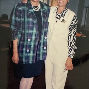 Two women standing next to each other in a room.