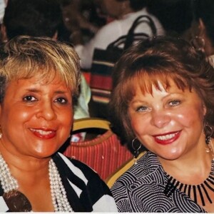 Two women posing for a photo at an event.