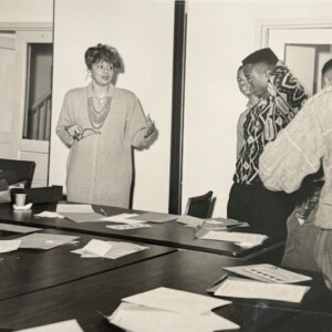 A group of people standing around a table.