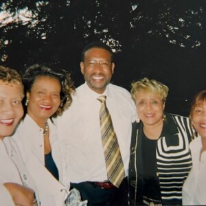 A group of women posing for a picture with a man.