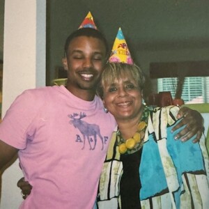 A man and woman posing for a photo at a birthday party.