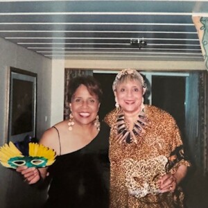 Two women posing for a picture in a room.