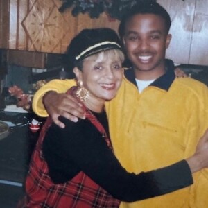 A man and woman hugging in a kitchen.