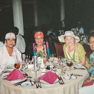 A group of women sitting at a table in a restaurant.