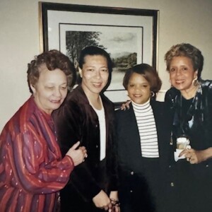 Three women posing for a picture in a living room.