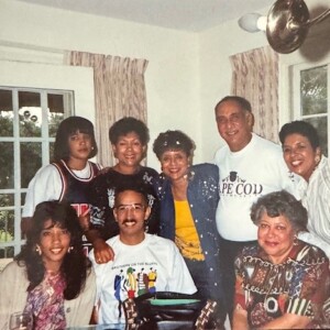 A group of people posing for a picture in a dining room.