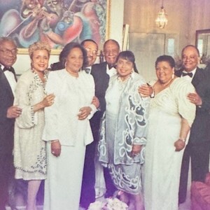 A group of people in formal attire posing for a photo.