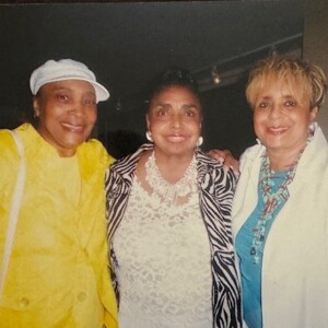 Three women posing for a photo with each other.