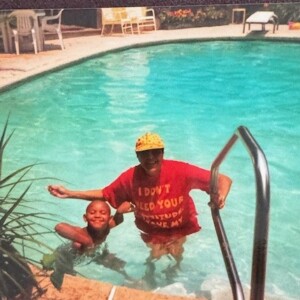 An old photo of a man and a child in a swimming pool.