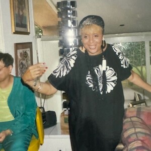 A man and woman standing in a living room.