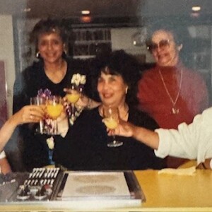 A photo of a group of women at a table with drinks.