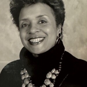 An old photo of a woman wearing a necklace.
