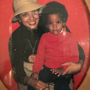 A picture of a woman and a child in a red frame.