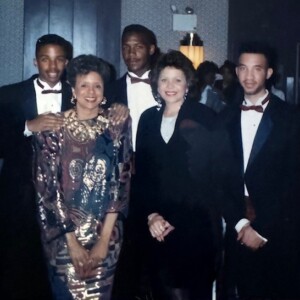A group of people in formal attire posing for a photo.