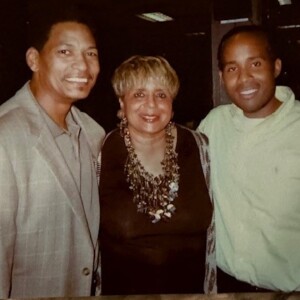 Two men and a woman posing for a photo.