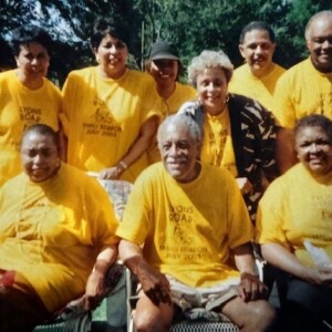 A group of people in yellow t - shirts posing for a photo.