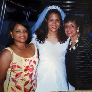 Two women posing for a picture in a wedding dress.