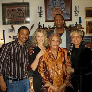 A group of people posing for a picture in a living room.