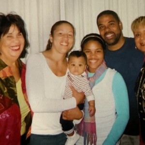 A group of people posing for a picture with a baby.